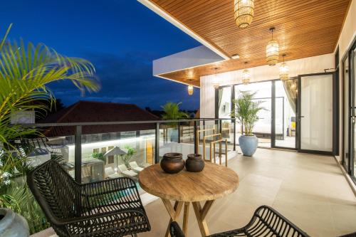 an indoor patio with a table and chairs at Zayana Villas Resort Seminyak in Seminyak