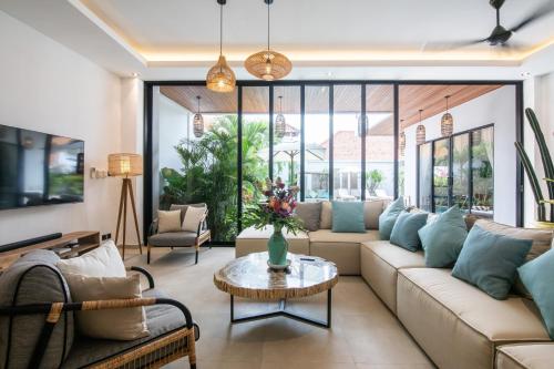 a living room with a couch and a table at Zayana Villas Resort Seminyak in Seminyak