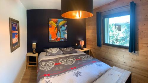 a bedroom with a bed and a window at Le Tremplin in Barcelonnette