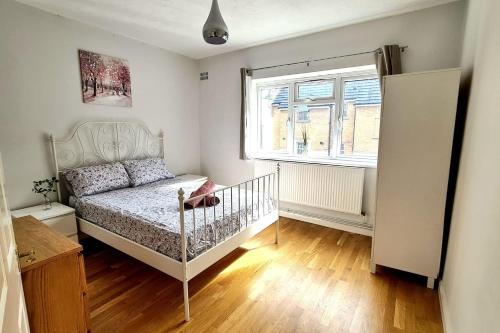 a small bedroom with a bed and a window at 5 SLEEPER CLOSE TO OLD STREET/ SHOREDITCH in London