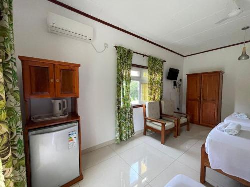 a room with a kitchen and a living room at Bethel's Villas in La Digue