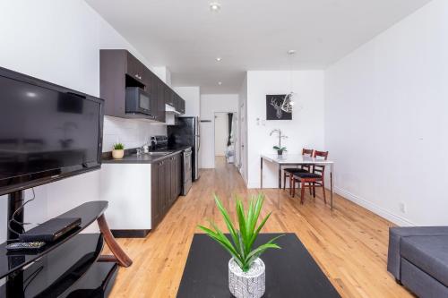 a living room with a kitchen and a dining room at AAA Location - Bright and Cozy Apartment in Montréal