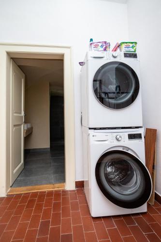 a washing machine and a washer in a room at Women's Only Hostel - Female Only in Prague