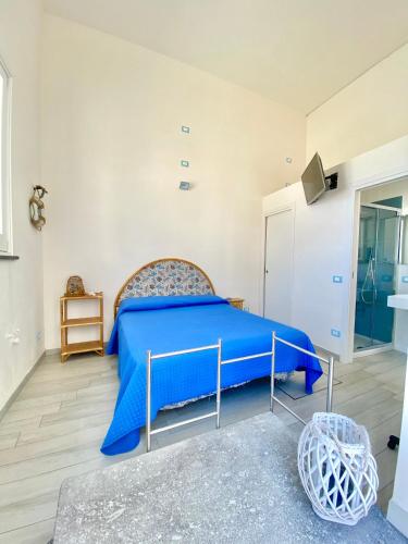 a bedroom with a blue bed in a room at Marettimo Appartamenti in Marettimo