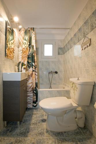a bathroom with a toilet and a sink and a tub at 3 Keys in Chalkida