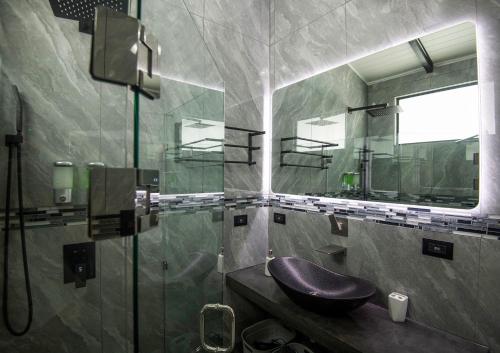 a bathroom with a purple sink and a mirror at Villa Roca Boutique Resort & Suites - ADULT ONLY in Manuel Antonio