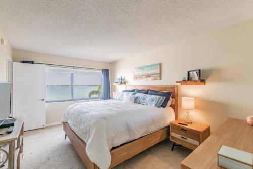 a bedroom with a bed and a window and a desk at La Puerta Beautiful Bayfront Condo in St Petersburg