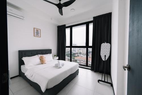 a bedroom with a bed and a large window at NEW Infinity Pool 3 Bedrooms 2 Carparks in Jelutong