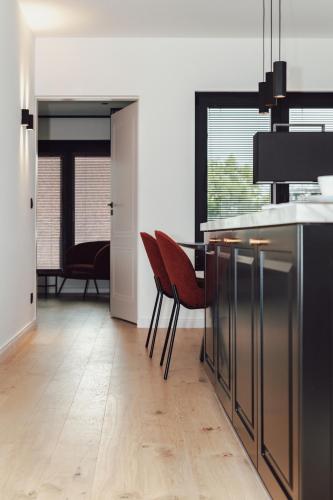 a kitchen with a table and chairs in a room at CH Longstay 33 in Kortrijk
