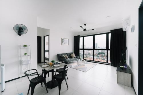 a white living room with a table and chairs at NEW Infinity Pool 3 Bedrooms 2 Carparks in Jelutong