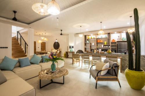 a living room with a couch and a table at Zayana Villas Resort Seminyak in Seminyak