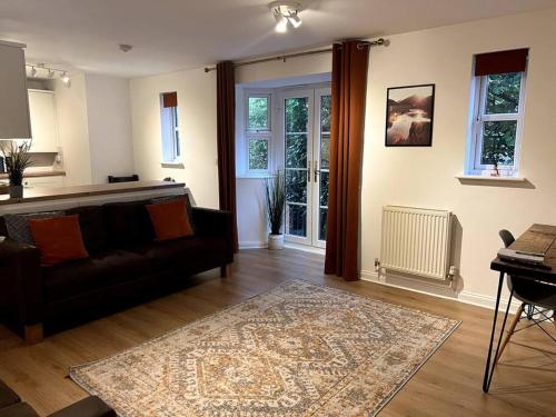 a living room with a couch and a table at The Quorndon in Kegworth