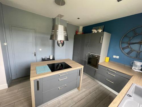 a kitchen with a counter and a sink in it at La Maison du Directeur - 224 in Déville-lès-Rouen