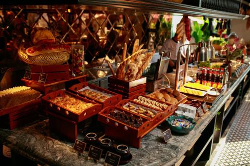 a buffet with many different types of food on a table at Grand Sunrise Palace Hoi An- A Luxury Indochine Hotel & Spa in Hoi An