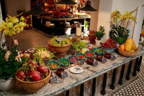a buffet of fruits and vegetables on a table at Grand Sunrise Palace Hoi An- A Luxury Indochine Hotel & Spa in Hoi An