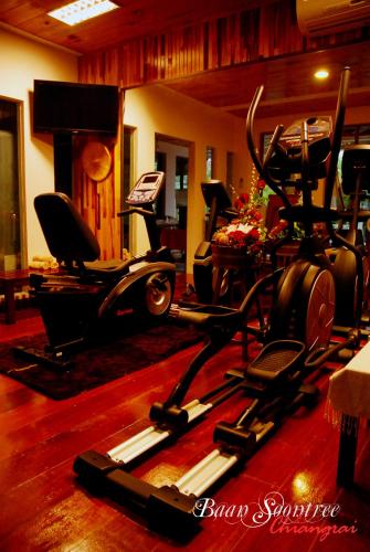 a gym with several exercise bikes in a room at Baan Soontree Resort in Chiang Rai