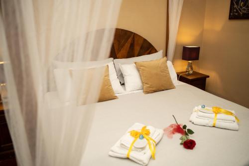a bedroom with a bed with towels and flowers on it at Navona Apartment in Rome