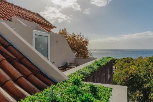 a balcony of a house with a view of the ocean at Oldtown in Funchal