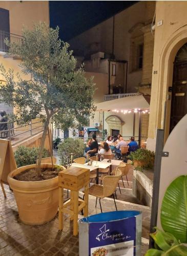 a restaurant with a table with a tree in it at mama home in Agrigento