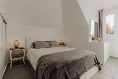 a white bedroom with a large bed and a window at SUPER Oldtown in Funchal