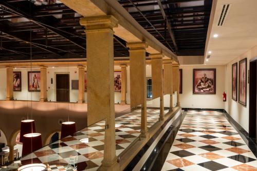 a lobby with columns and a checkered floor at Vila Gale Collection Tomar in Tomar