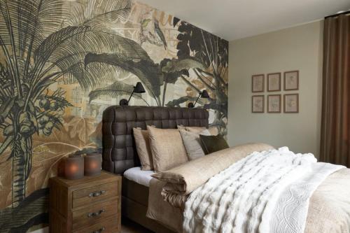 een slaapkamer met een bed en tropisch behang bij Brasserie Spoorhuis Mijdrecht in Mijdrecht