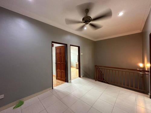 a living room with a ceiling fan and a hallway at Muslim Suite Home @ Airport Bayan Lepas Penang in Bayan Lepas