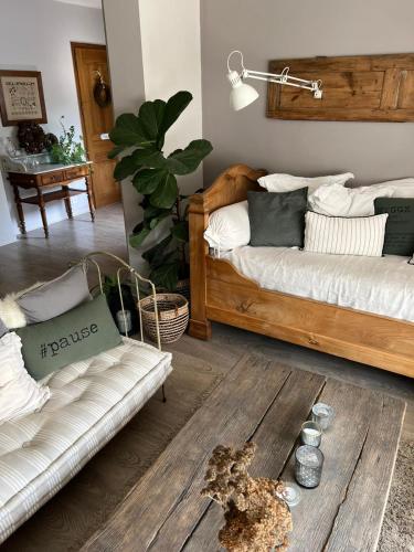 a living room with two beds and a wooden floor at Les chambres de Pauline avec spa et climatisation parking moto garage vélo in Albertville