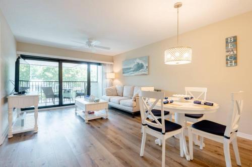 a living room with a table and a couch at Park Shore Resort Beautiful Top Floor 2Bed 2Bath in Naples