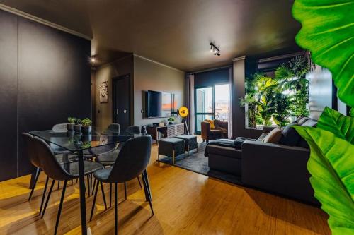 a living room with a table and a couch at Golden in Funchal