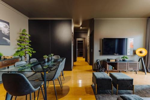 a living room with a table and chairs and a tv at Golden in Funchal