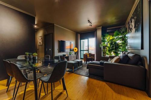 a living room with a table and a couch at Golden in Funchal