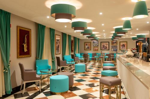 a waiting room at a salon with blue chairs at Vila Gale Collection Tomar in Tomar