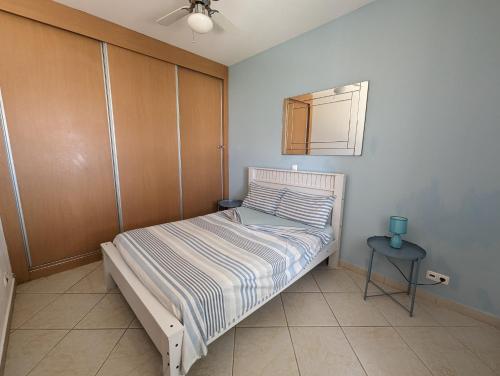 ein kleines Schlafzimmer mit einem Bett und einem Tisch in der Unterkunft Vila Cabral 1 Bed Apt - Wi-Fi & Air Con Included in Sal Rei