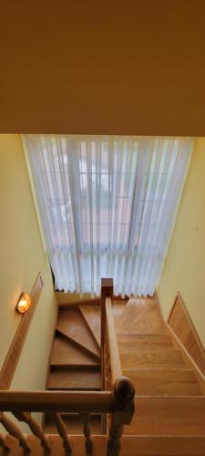 a room with a staircase with a window at Apartamentos Rurales Argame in Argamé