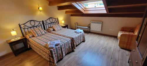 a bedroom with a large bed and a window at Apartamentos Rurales Argame in Argamé