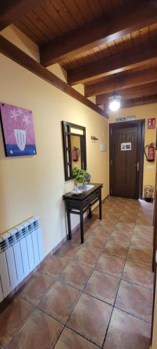 an empty room with a table and a door at Apartamentos Rurales Argame in Argamé