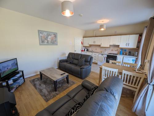 a living room with a couch and a table at Derg Valley Apartments in Castlederg