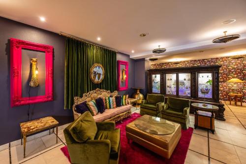 a living room with a couch and some chairs at Zeitgeist Rathen by STEIGER Hotels in Kurort Rathen