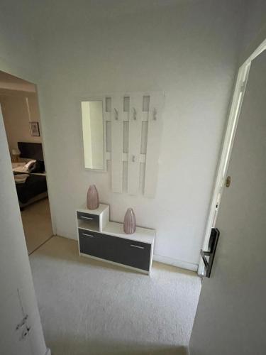a room with a table with vases on the wall at Vue du Château d'Excideuil en chambres in Excideuil