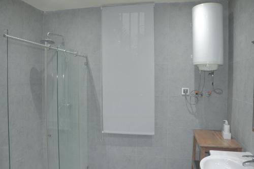 a bathroom with a shower and a sink at Industria Villa in Malabo