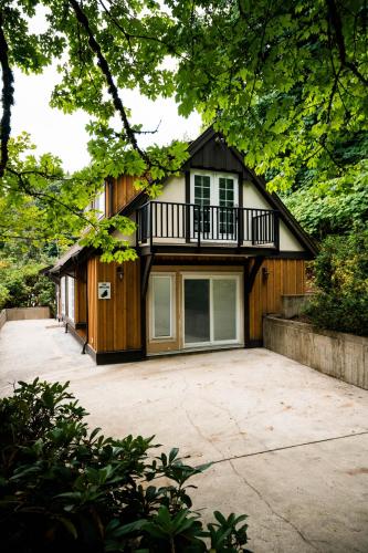 a house with a balcony on top of a driveway at Private Mountainside Home in Chilliwack