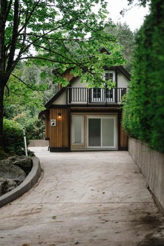 a house with a balcony on top of a driveway at Private Mountainside Home in Chilliwack