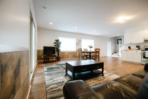 a living room with a couch and a table at Private Mountainside Home in Chilliwack