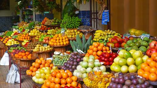 a display of fruits and vegetables in a market at Ocean Paradise do Til in Funchal