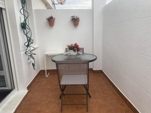 a small table and a chair in a small room at Rincón de Cantabria 1 in Santoña
