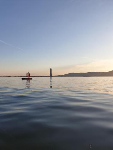 a lighthouse in the middle of a body of water at The Viewpoint in Newry