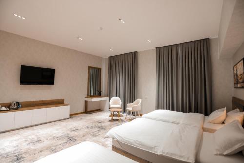 a hotel room with a bed and a television at PREMIER HOTEL in Andijan
