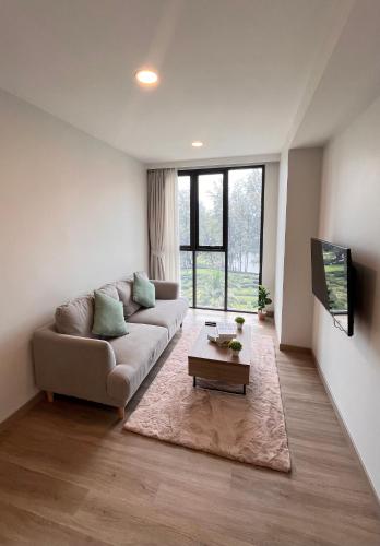 a living room with a couch and a coffee table at Sky Park Laguna 1bdr Lake View in Thalang