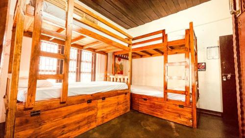 a bedroom with two bunk beds and a ladder at Zebra Hostels in Varkala
